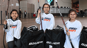 Three girls with hockey gear
